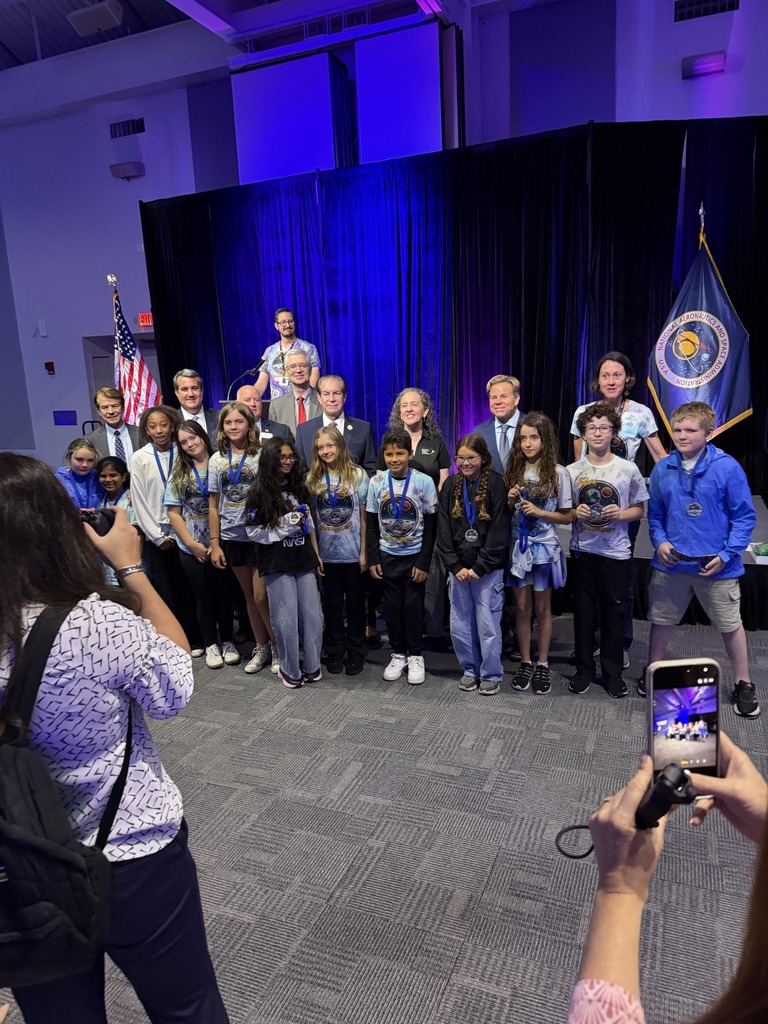 A group of students standing with their trophy