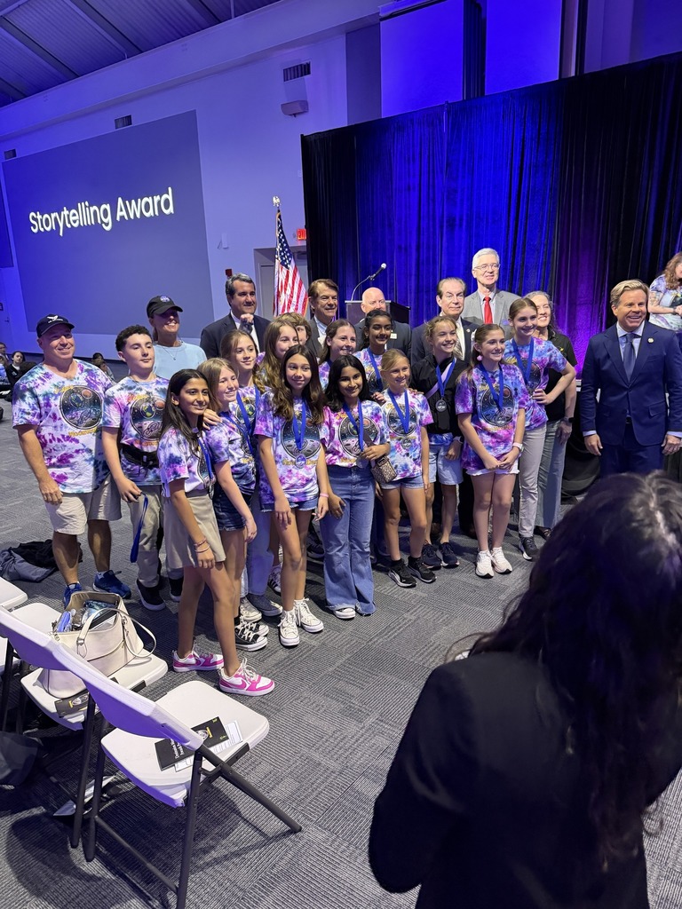 A group of students standing with their trophy