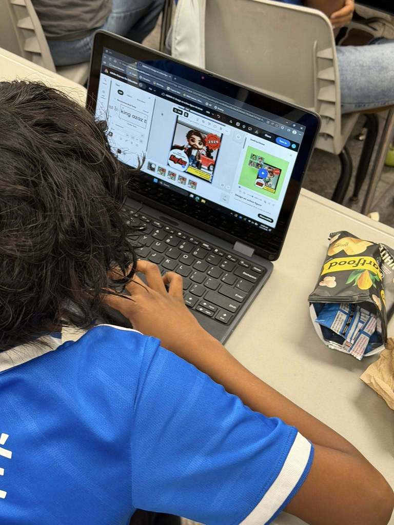 students sitting at their desks working on their computers creating with Canva