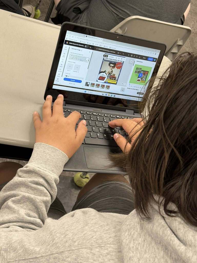 students sitting at their desks working on their computers creating with Canva