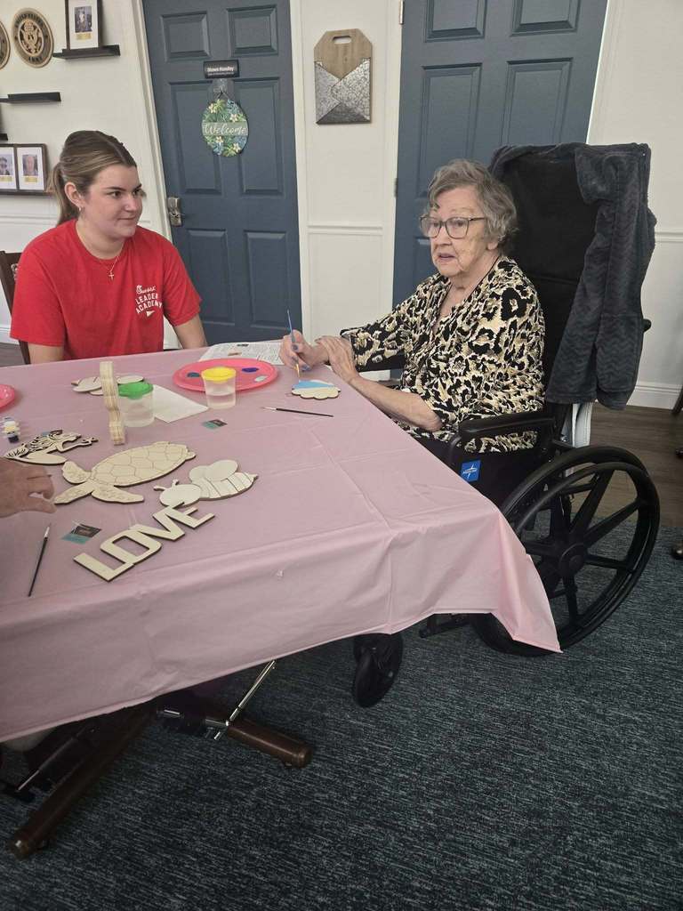 students helping seniors with craft