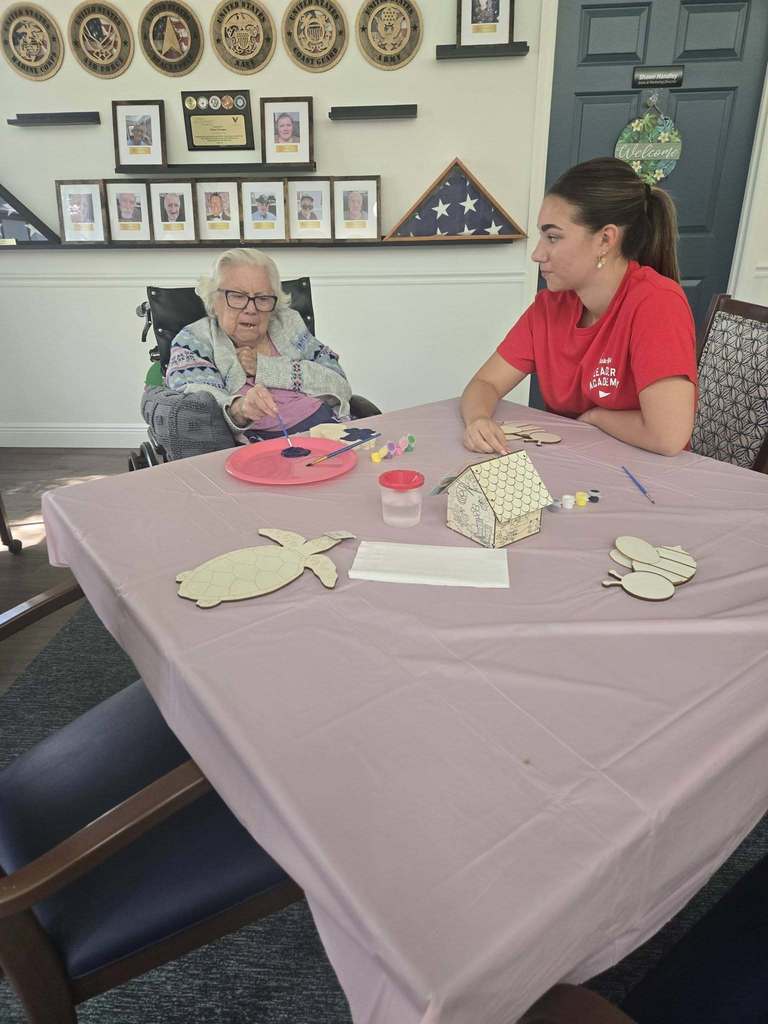 students helping seniors with craft