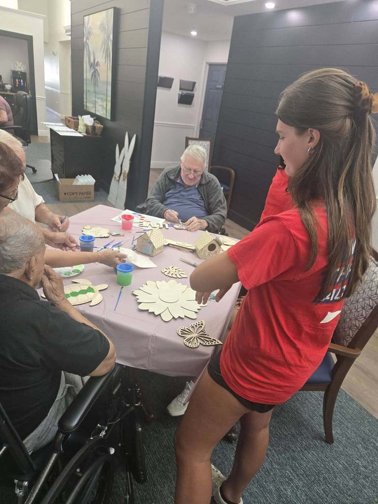 students helping seniors with craft