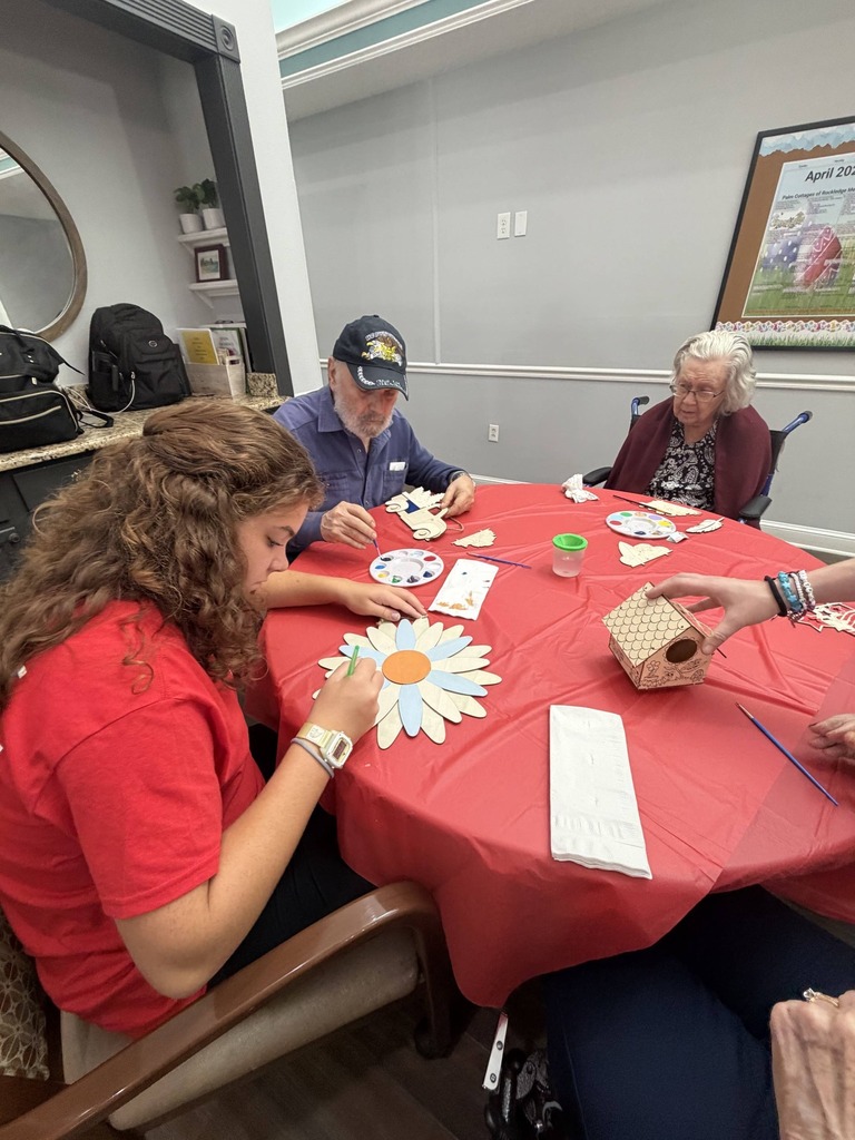 students helping seniors with craft