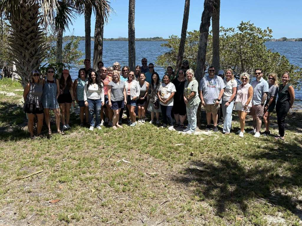 the entire group of participants and trainers standing by the Indian river Lagoon