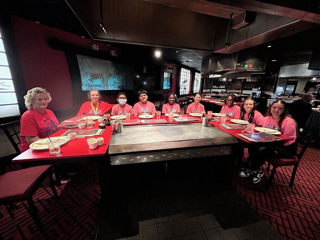 Students and adults sitting at makotos hibachi table
