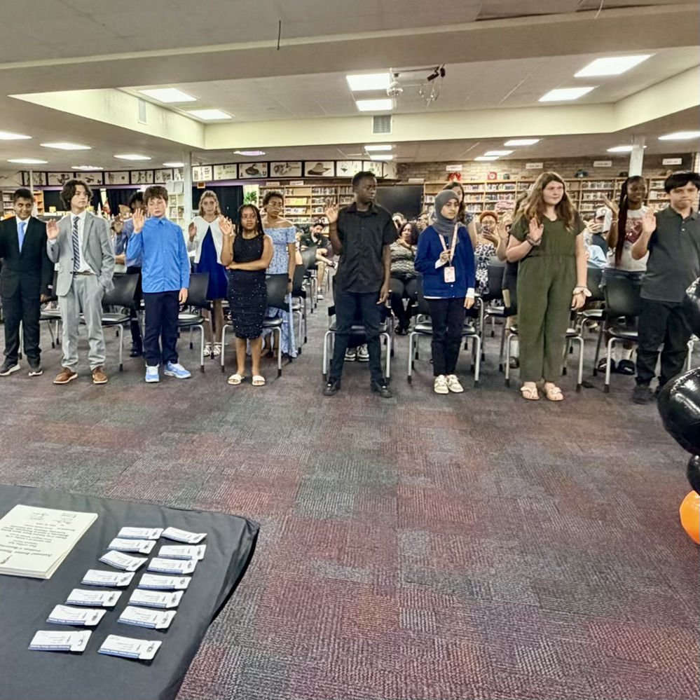 students standing and being inducted into njhs and beta