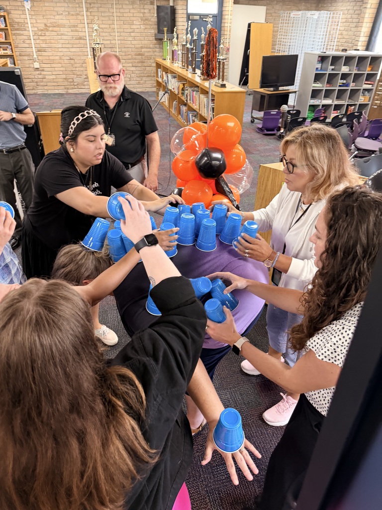 teacher's playing a team building competition of who could stack the most cups on to of the teacher