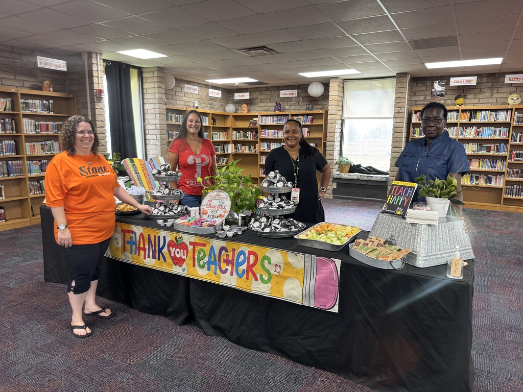 image of stone teachers standing around food table
