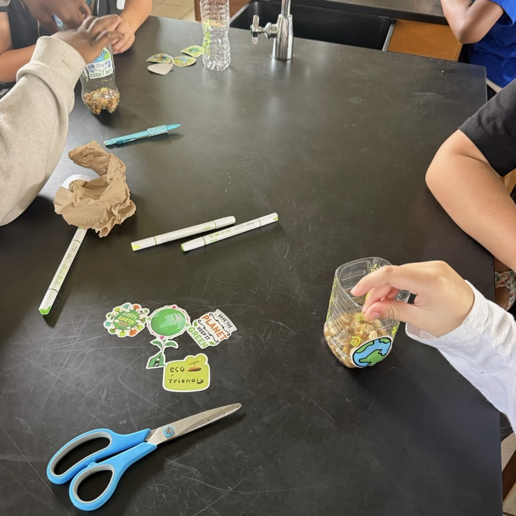 students making planters out plastic bottles