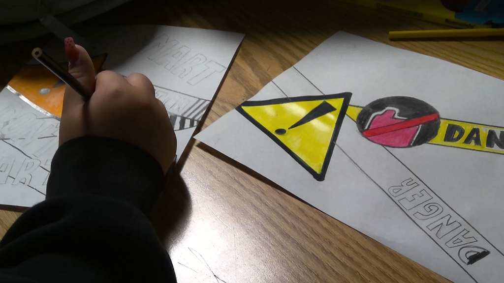 image a student working on drawing an anti-vaping poster