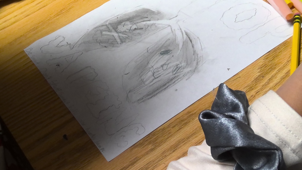 image a student working on drawing an anti-vaping poster