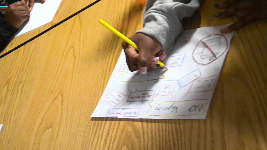 image a student working on drawing an anti-vaping poster