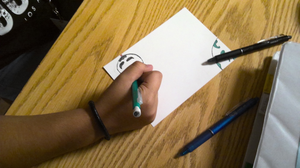 image a student working on drawing an image that will go into space.