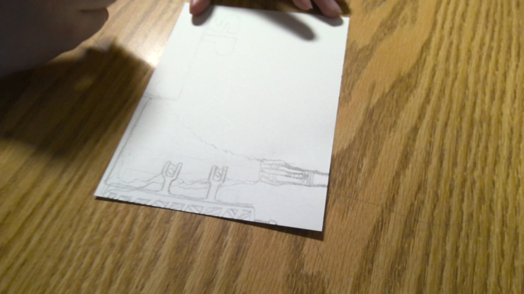 image a student working on drawing an image that will go into space.