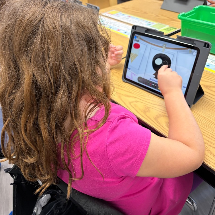 Kindergarten student using an iPad during an “All About Me” drawing her favorite animal.