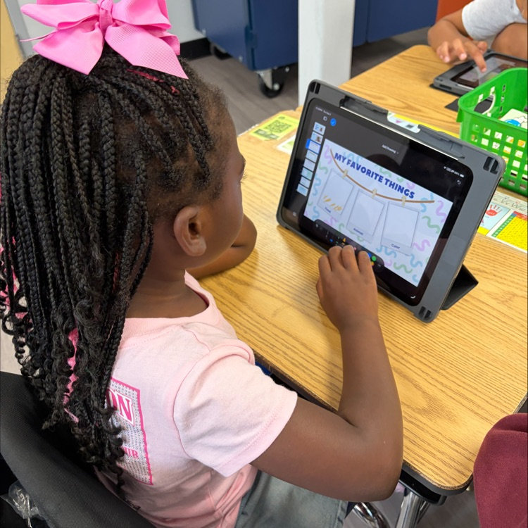 Kindergarten student using an iPad during an “All About Me” drawing her favorite food.