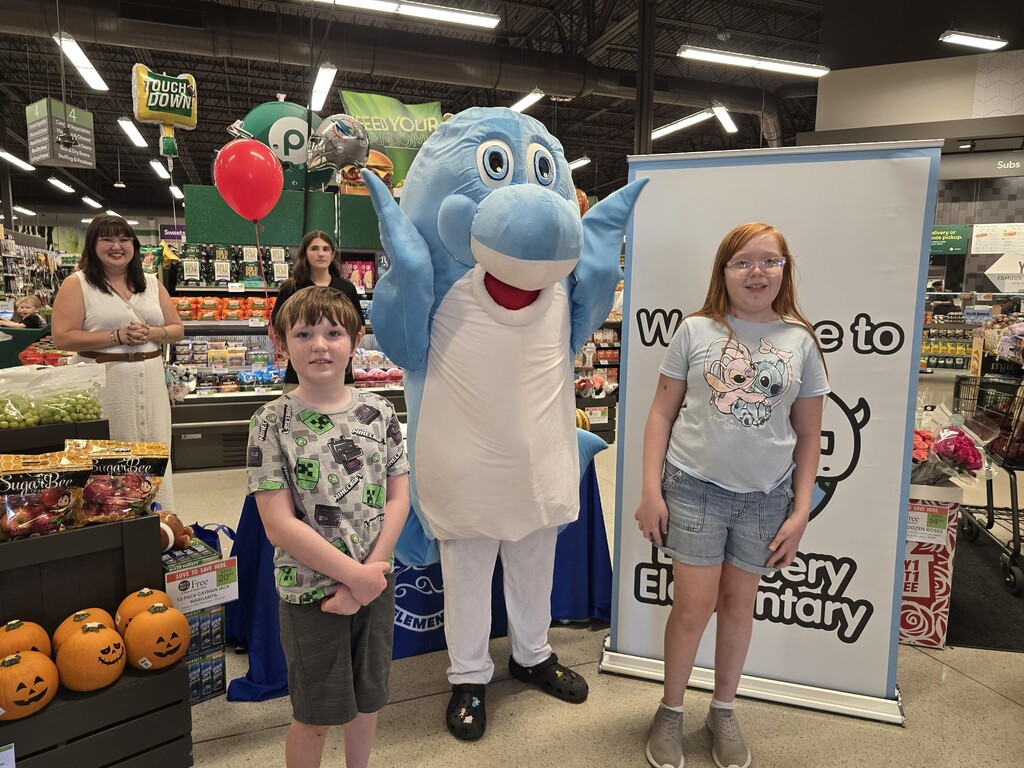Students posing with the Discovery mascot at the Publix Math night