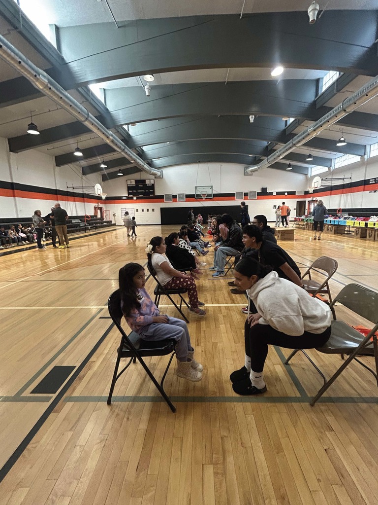 High School student talking to TK student