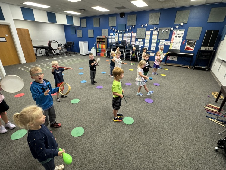 PreK doing the Fight Song with instruments .
