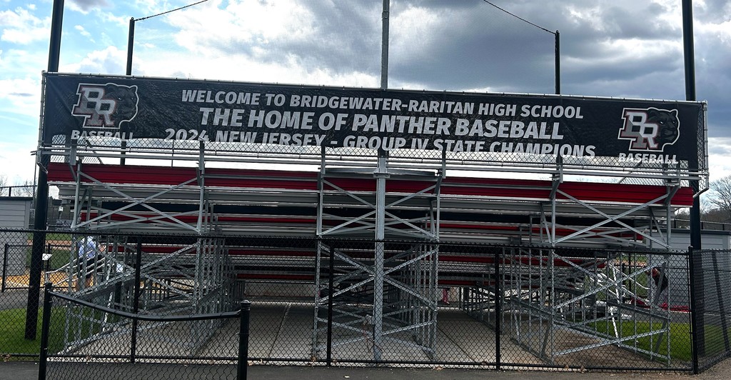 sign behind bleachers