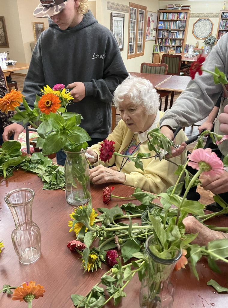 Students assisted residents in making flower arrangements