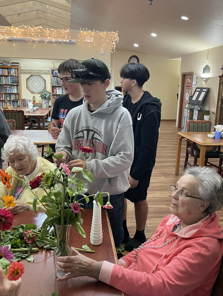 Students assisted residents in making flower arrangements