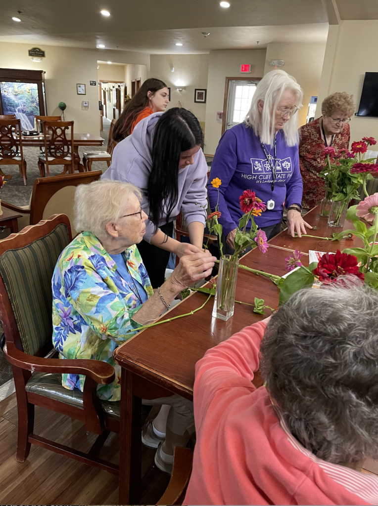 Students assisting with flower arrangements