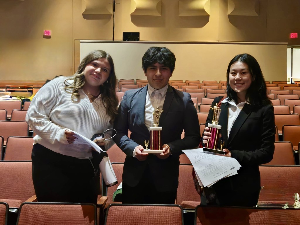 This is a photograph of three students who participated in the forensics competition at Science Hill.