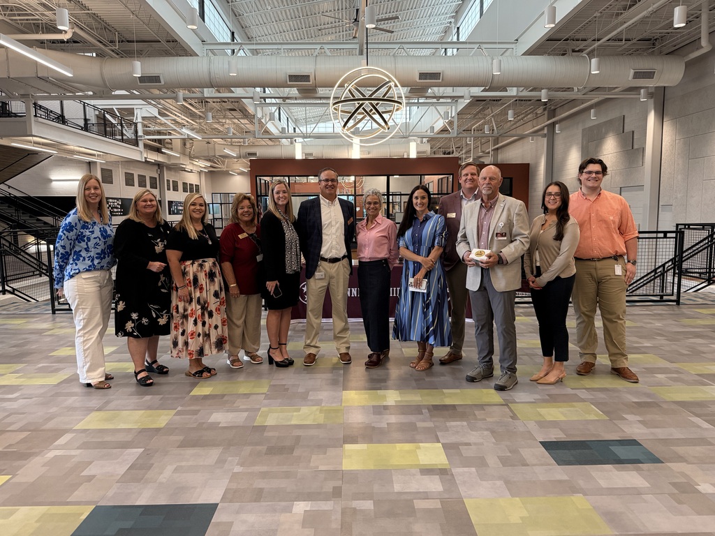 Group photo of Tennessee Department of Education Commissioner Lizzette Reynolds, Tennessee Department of Education staff, and Bristol Tennessee City Schools administrators and staff standing together in the commons area at Tennessee Middle School during the department's visit to the district's Summer STREAM program.