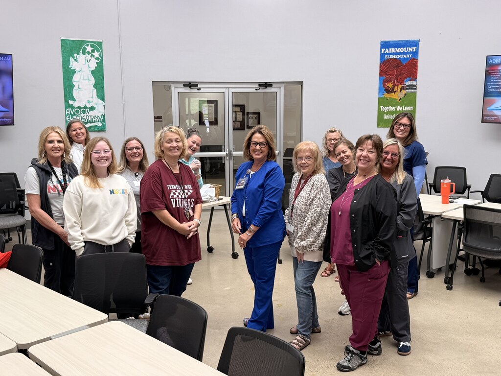 Group of Bristol Tennessee City Schools nurses and community partners smiling together during a school nurse training session.