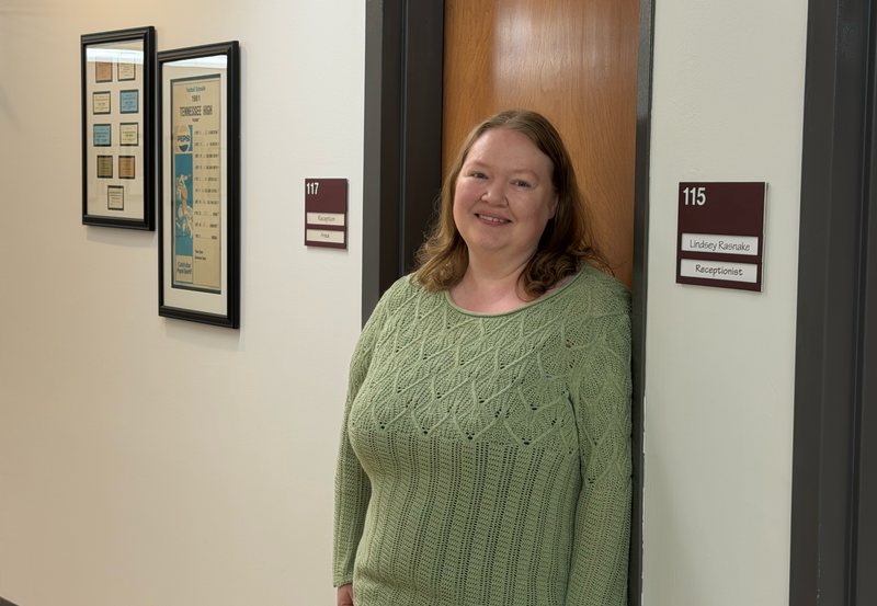 Lindsey Rasnake, Bristol Tennessee City Schools receptionist, smiles while standing in the hallway outside her office at the district’s central office.