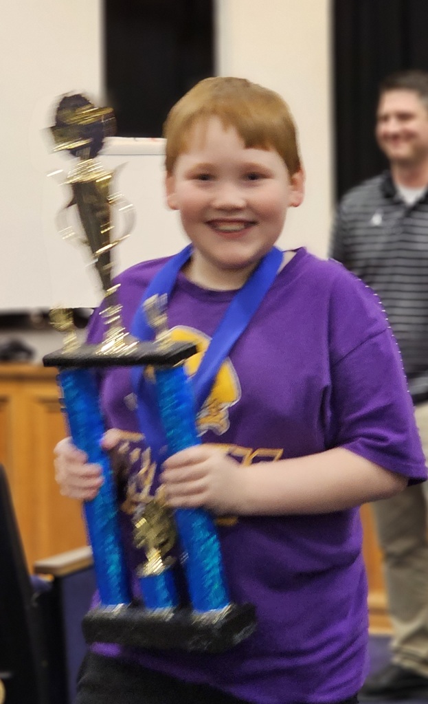 Bradyn Douglas holding a trophy.