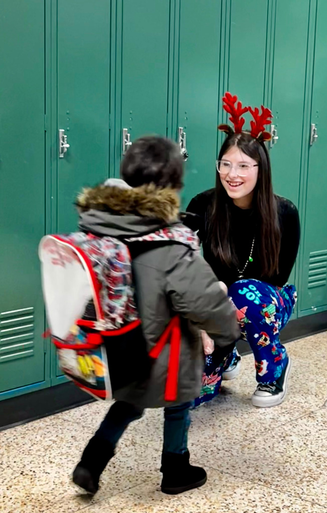 London Lanphere hands an elementary student a candy cane.