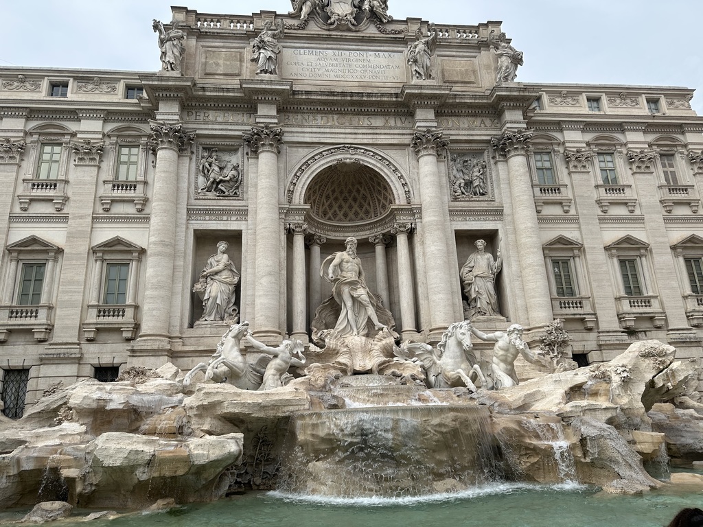 Trevi Fountain, adorned with detailed statues and clear water, where Travel Club members tossed coins, hoping for a return visit one day