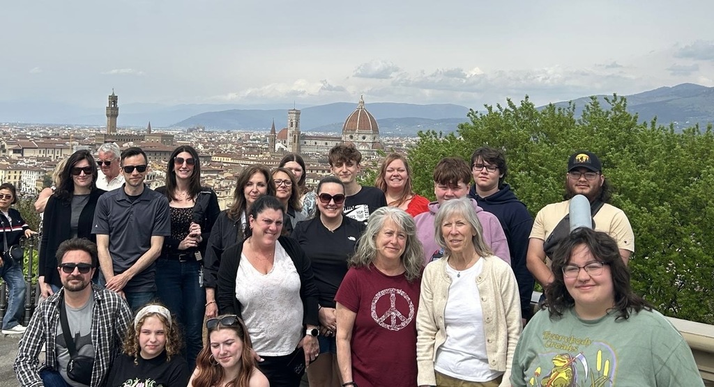 Travel Club in a group photo with the city of Florence in the background