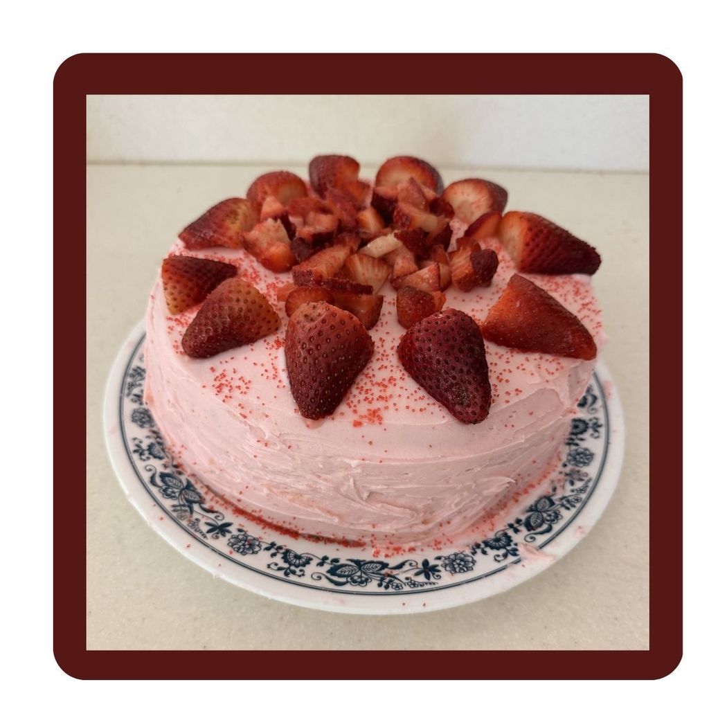 Pink cake with strawberries on top