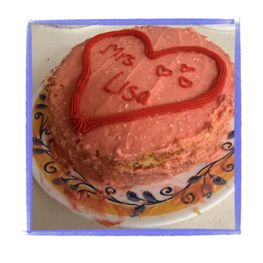 Pink cake with Mrs. Lisa spelled inside a heart.