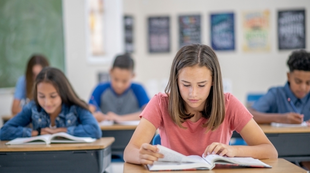 Picture of students reading an assignment.