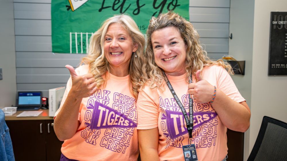 Broken Arrow teachers with thumbs up.