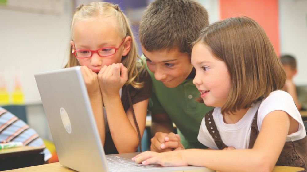 Students looking at computer screen.