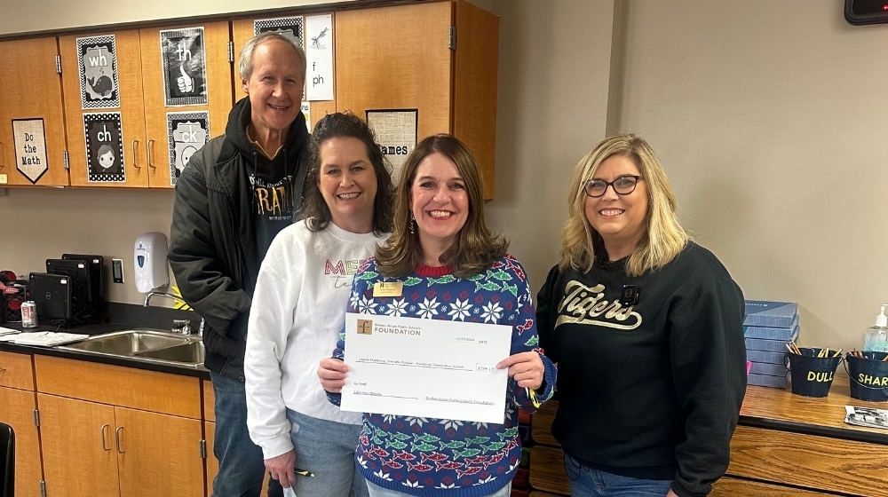 Teacher receiving teacher grant from BAPS' Foundation