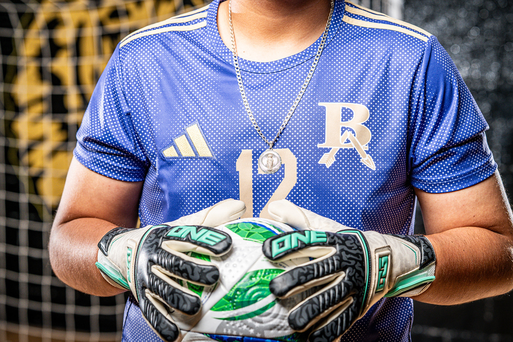 Male goalie holding soccer ball