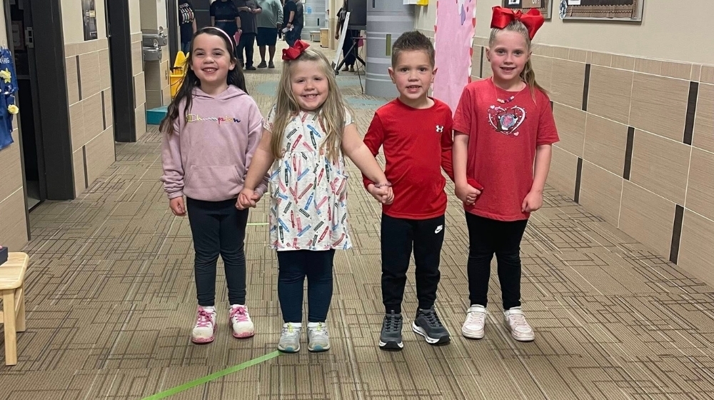 Picture of Pre-K students in the hallway.