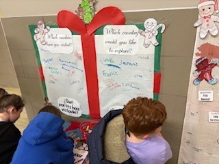 Students used a map to answer the questions posed on the wall.
