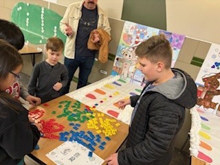 Students making sentences using tiles.