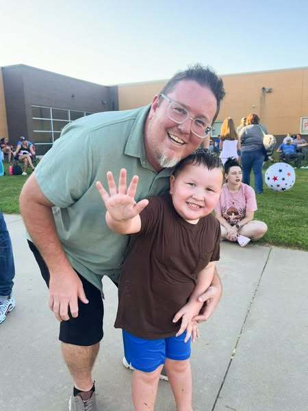 Dad and son at school event.