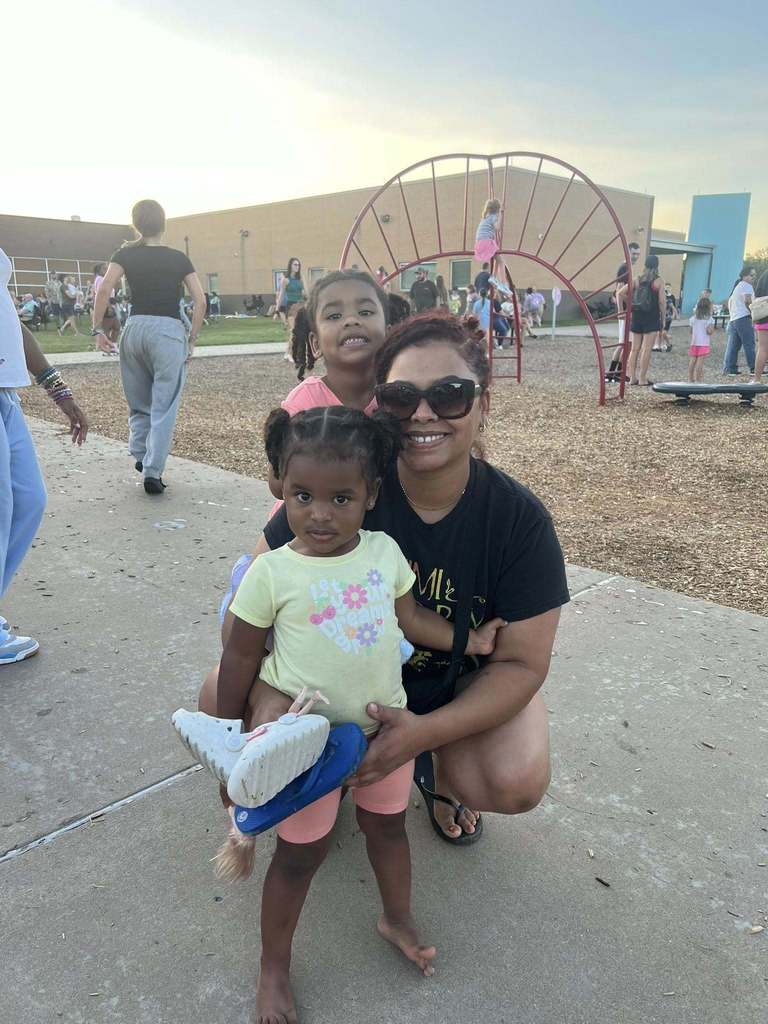 Mom and daughters at school event.