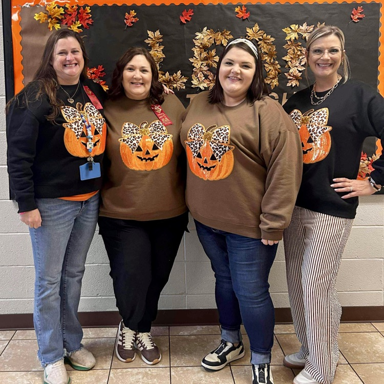 4 teachers w pumpkin shirts on