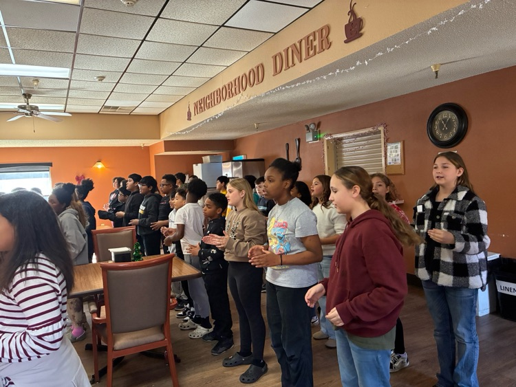 students in a line singing 